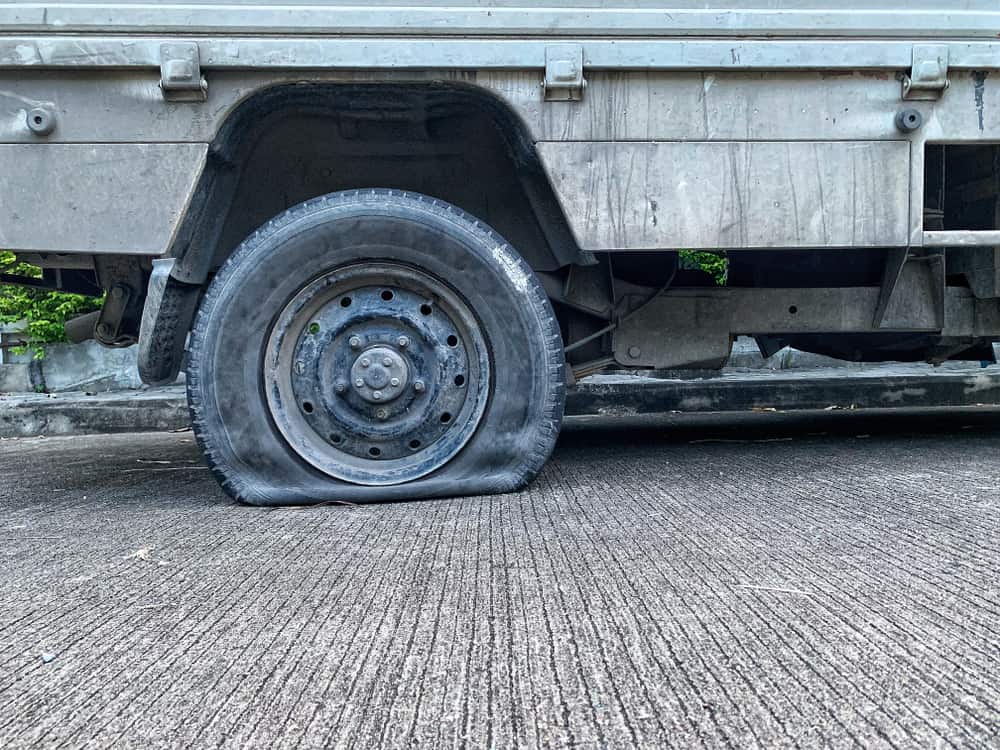 picture of flat tire on large vehicle.